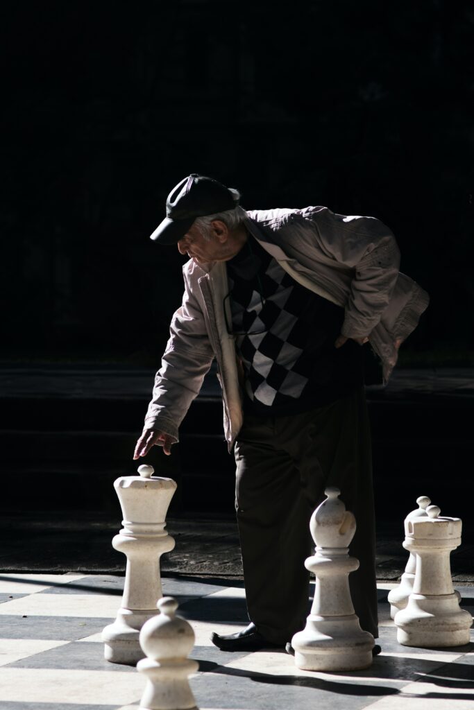 Elderly gentleman, playing giant chess.